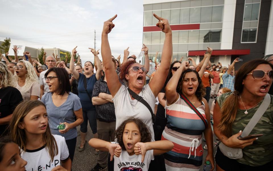 Demonstrators cheer after it's announced that an outdoor rally planned for Justin Trudeau, Canada's prime minister, is cancelled, in Bolton, Ontario, Canada - Bloomberg