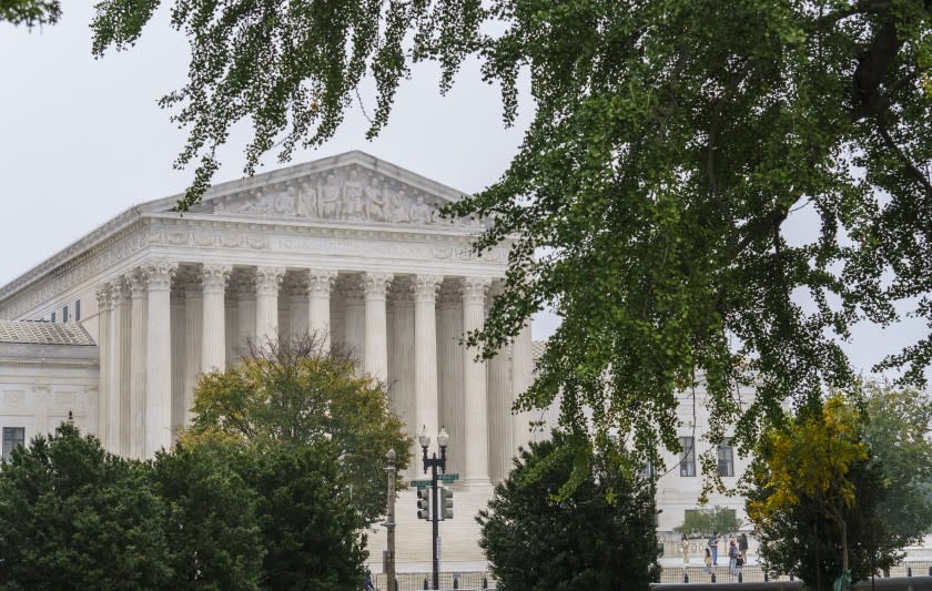 The Supreme Court is seen as morning fog lingers on Capitol Hill in Washington, Wednesday, Oct. 21, 2020. (AP Photo/J. Scott Applewhite)