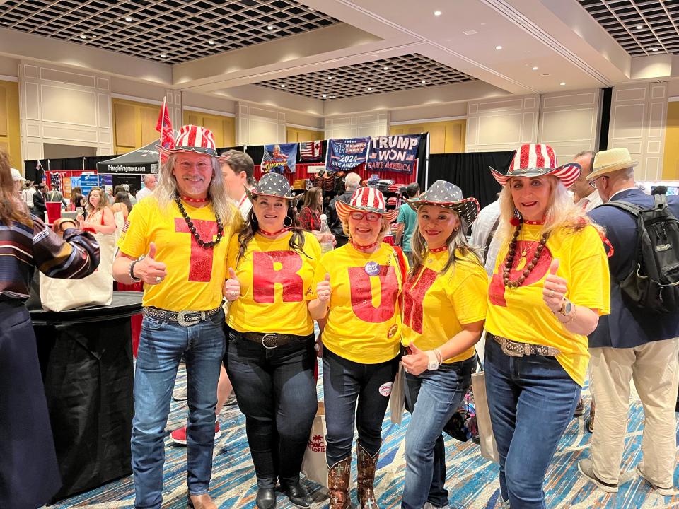 Trump supporters at CPAC spell out the former president's name.