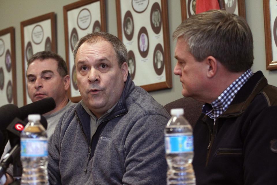 Canadian National Railway CEO Claude Mongeau, center, and New Brunswick Premier David Alward answer questions about a train derailment at a news conference in Plaster Rock on Wednesday Jan. 8, 2014. Officials say a derailed freight train carrying crude oil and propane is continuing to burn, and about 150 people are still being kept away from their homes. There were no deaths or injuries from the derailment. The chief executive of CN Rail says of the 17 cars that derailed in New Brunswick late yesterday, five contain crude oil and four contain propane. He says some of the propane cars are venting and some of the crude cars are burning. (AP Photo/The Canadian Press, Tom Bateman)