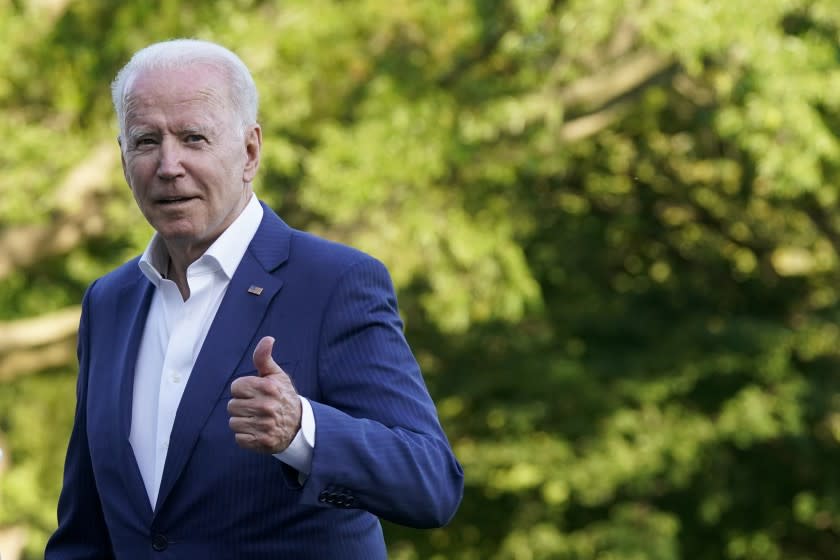 President Joe Biden gestures as he walks on the South Lawn of the White House after stepping off Marine One, Sunday, June 27, 2021, in Washington. Biden is returning from a weekend at Camp David. (AP Photo/Patrick Semansky)