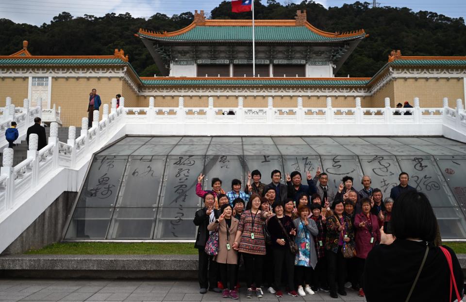 Tourists pose for photos in front of Taiwan's National Palace Museum in Taipei on March 13, 2019. (Photo by Sam YEH / AFP)        (Photo credit should read SAM YEH/AFP/Getty Images)