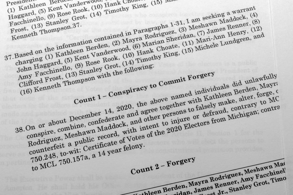 The affidavit in support of an arrest warrant for 16 fake Republican electors for Donald Trump in the 2020 presidential election in Michigan is photographed Tuesday, July 18, 2023. Michigan Attorney General Dana Nessel has charged 16 Republicans with multiple felonies after they are alleged to have submitted false certificates stating they were the state's presidential electors despite Joe Biden's 154,000-vote victory in 2020. (AP Photo/Jon Elswick)