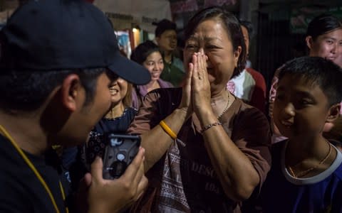 Onlookers at Chiangrai Prachanukroh Hospital watch and cheer as ambulances transport the last rescued schoolboys and their coach from a helipad nearby to Chiangrai Prachanukroh Hospital on July 10, 2018 in Chiang Rai, Thailand. - Credit: Linh Pham/Getty Images AsiaPac