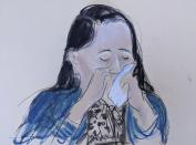 In this courtroom sketch drawn from a video feed, Meng Wanzhou, chief financial officer of Huawei Technologies, breaks down and cries as she appears via video prior to her hearing in Brooklyn Federal Court. Friday, Sept. 24, 2021, in New York. The top executive of Chinese communications giant Huawei Technologies has resolved criminal charges against her as part of a deal with the U.S. Justice Department that could pave the way for her to return to China and that concludes a case that roiled relations between Washington and Beijing. (AP Photo/Elizabeth Williams)