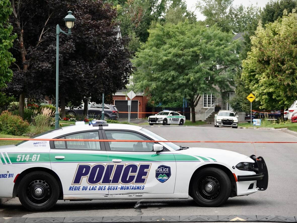 The Deux-Montagnes police service were called to a home in Sainte-Marthe-sur-le-Lac, Que., about 40 kilometres west of Montreal, around 11:45 p.m. Wednesday. (Simon-Marc Charron/Radio-Canada - image credit)