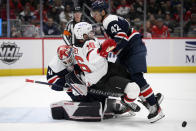 Washington Capitals defenseman Martin Fehervary (42) and goaltender Vitek Vanecek (41) collide with New Jersey Devils left wing Jimmy Vesey (16) during the second period of an NHL hockey game Saturday, March 26, 2022, in Washington. (AP Photo/Nick Wass)