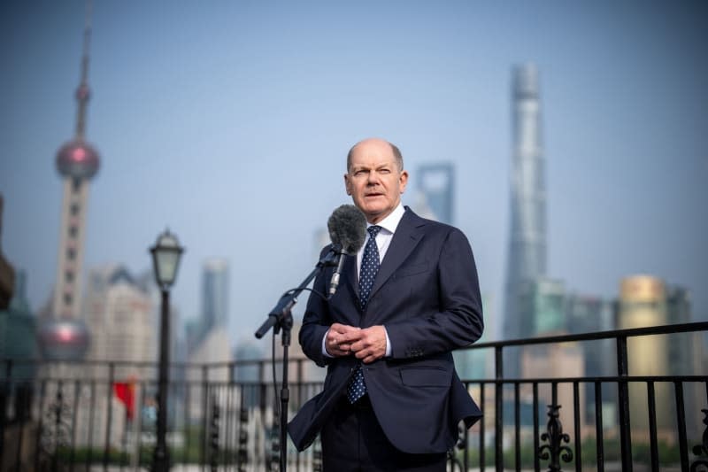 Germany's Chancellor Olaf Scholz speaks during a press statement in Shanghai. Scholz is scheduled to meet China's President Xi Jinping in Beijing at the end of his trip. Michael Kappeler/dpa