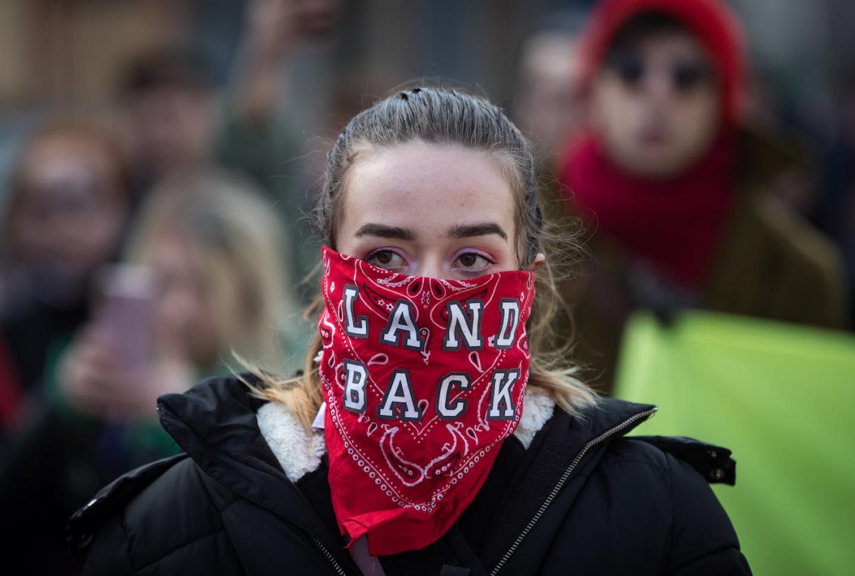 A woman takes part in a demonstration in Vancouver against the construction of a natural gas pipeline through traditional Wet'suwet'en territories, in February 2020. THE CANADIAN PRESS/Darryl Dyck