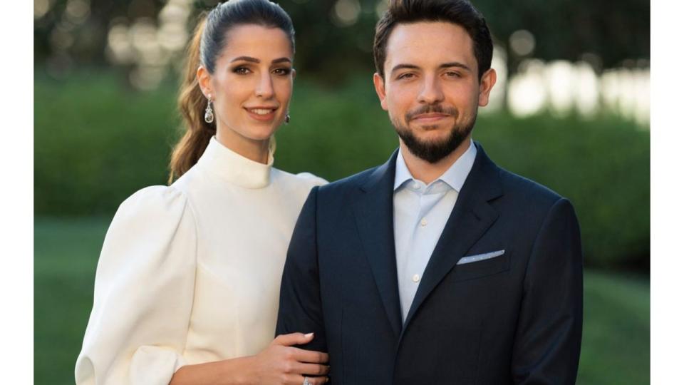 Jordan's Crown Prince Hussein in a suit with his fiancee Rajwa Al Saif wearing a white dress