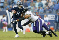 Tennessee Titans quarterback Marcus Mariota (8) is sacked by Baltimore Ravens defensive end Chris Wormley (93) for a 6-yard loss in the first half of an NFL football game Sunday, Oct. 14, 2018, in Nashville, Tenn. (AP Photo/Wade Payne)