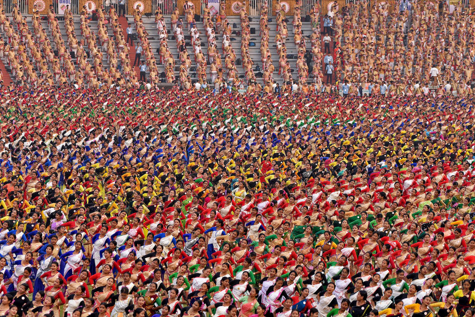 Participants wearing colorful attire perform the Bihu dance, a traditional folk dance, to try to set a Guinness World Record for the largest Bihu dance performance in the world at a single venue, in Guwahati, India, on April 13, 2023. 