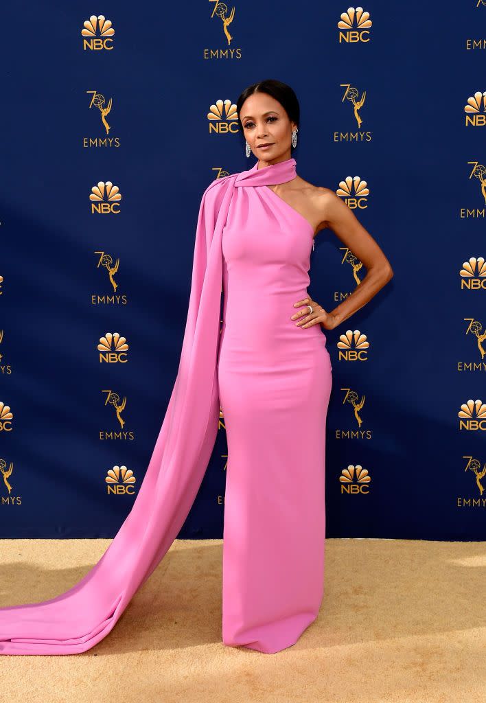 <p>In a Pepto-pink fitted gown with a one-shouldered train. </p>