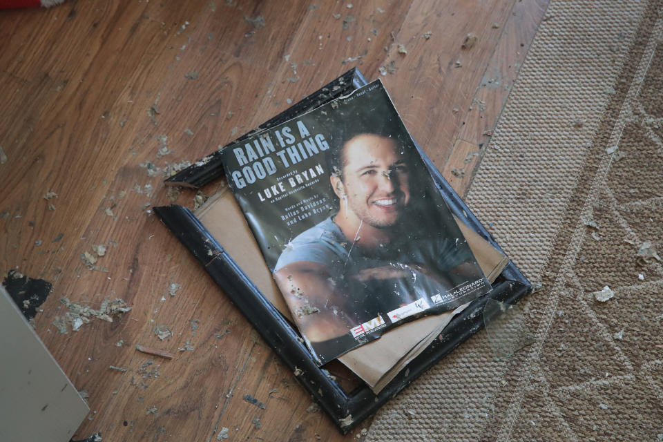 A framed memento from her son's music career lays broken on the floor of the home of LeClaire Bryan, mother of country music artist Luke Bryan, after it was severely damaged by Hurricane Michael on October 19, 2018 in Mexico Beach, Florida.