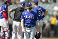 Texas Rangers starting pitcher Drew Anderson, foreground, reacts as he is removed for a reliever during the sixth inning of a baseball game against the Oakland Athletics, Sunday, Aug. 8, 2021, in Oakland, Calif. (AP Photo/D. Ross Cameron)