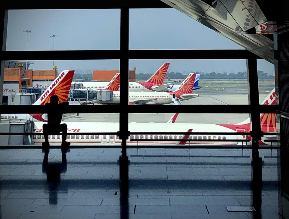 FILE- Air India planes are parked at Indira Gandhi International Airport in New Delhi, India on Aug. 30, 2021. Indian police have arrested an unruly airline passenger following a complaint by a woman aboard an Air India flight from New York that he urinated on her in business class. (AP Photo/Manish Swarup, File)