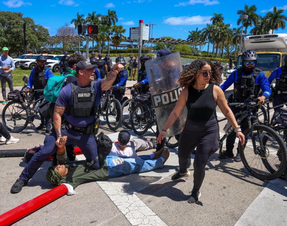 About seven protesters lay down in the intersection of NE 3rd Street and northbound Biscayne Blvd and were later arrested by Miami Police on Monday, April 15, 2024, in downtown Miami, Florida. Carl Juste/cjuste@miamiherald.com