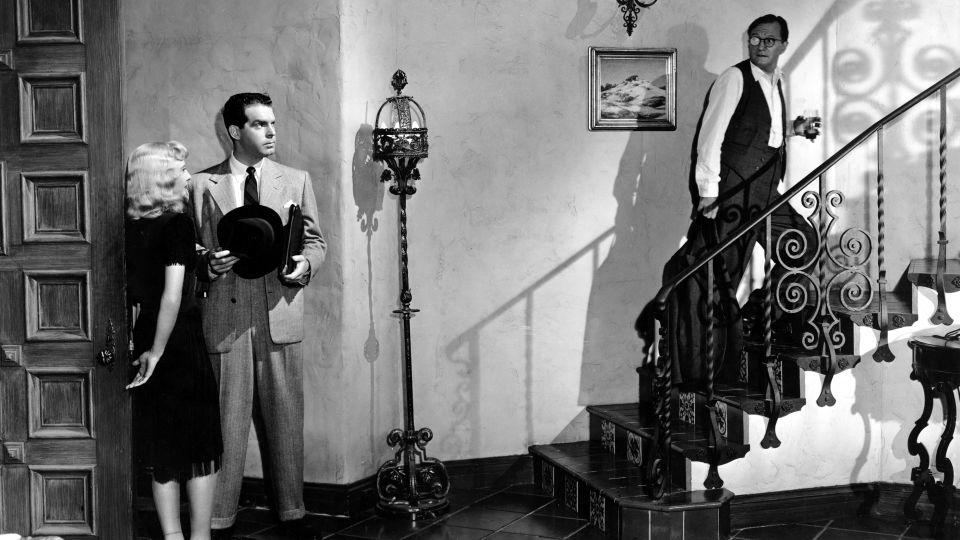 Barbara Stanwyck, Fred MacMurray and Tom Powers are pictured in Billy Wilder's "Double Indemnity." - Everett Collection