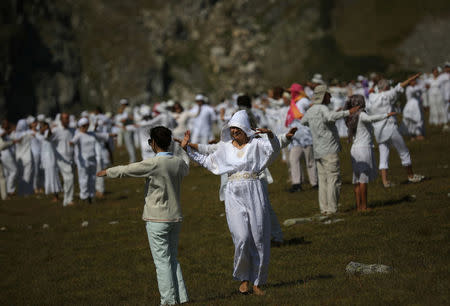 Followers of the Universal White Brotherhood, an esoteric society that combines Christianity and Indian mysticism set up by Bulgarian Peter Deunov in the 1920s, perform a dance-like ritual called "paneurhythmy" in Rila Mountain, Bulgaria, August 19, 2017. REUTERS/Stoyan Nenov