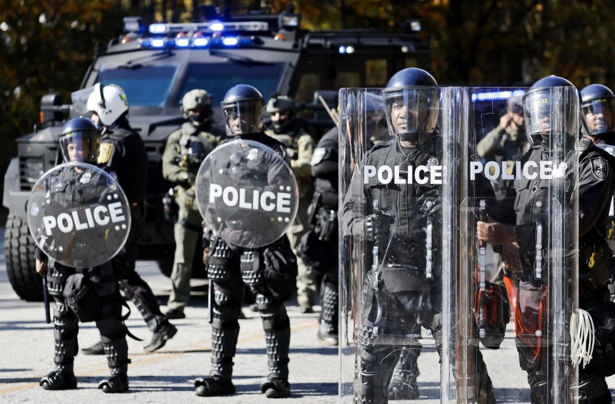 <span>Atlanta police officers respond to protesters at the construction site of ‘Cop City’, on 13 November 2023.</span><span>Photograph: Erik S Lesser/EPA</span>