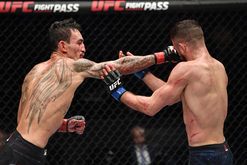 ABU DHABI, UNITED ARAB EMIRATES - JANUARY 17: (L-R) Max Holloway punches Calvin Kattar in a featherweight bout during the UFC Fight Night event at Etihad Arena on UFC Fight Island on January 17, 2021 in Abu Dhabi, United Arab Emirates. (Photo by Jeff Bottari/Zuffa LLC)