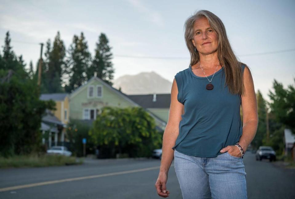 Angelina Cook, a Democrat and longtime Siskiyou County resident, is running her second campaign for a seat on the non-partisan Siskiyou County Board of Supervisors. She stands on Main Street in McCloud on Aug. 8 with Mount Shasta in the distance. Xavier Mascareñas/xmascarenas@sacbee.com
