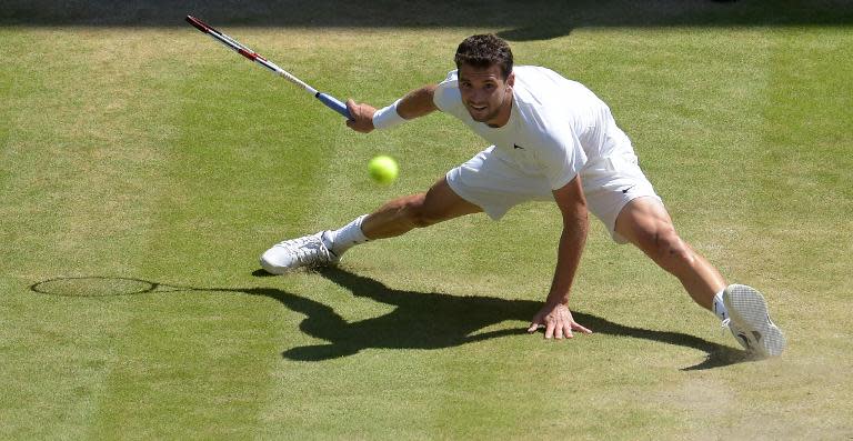 Bulgaria's Grigor Dimitrov returns to Serbia's Novak Djokovic during their match at the Wimbledon Championships in London, on July 4, 2014