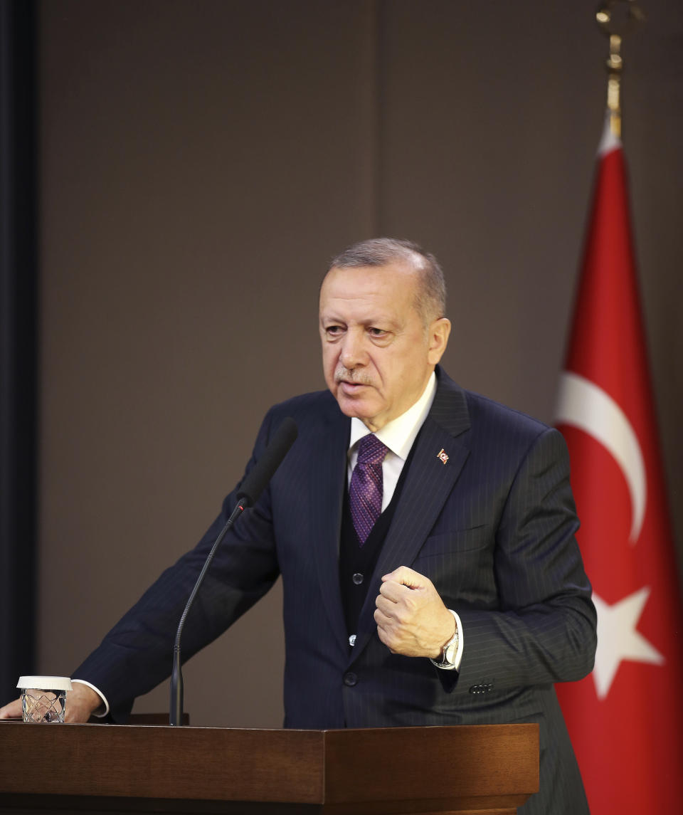 Turkey's President Recep Tayyip Erdogan speaks before departing to attend a NATO leader's summit in London, in Ankara, Turkey, Tuesday, Dec. 3, 2019. Erdogan says there is no change in Turkey's position that is holding up a NATO defense proposal for Poland and Baltic nations until the alliance supports Ankara's concerns related to Syrian Kurdish fighters.(Presidential Press Service via AP, Pool)