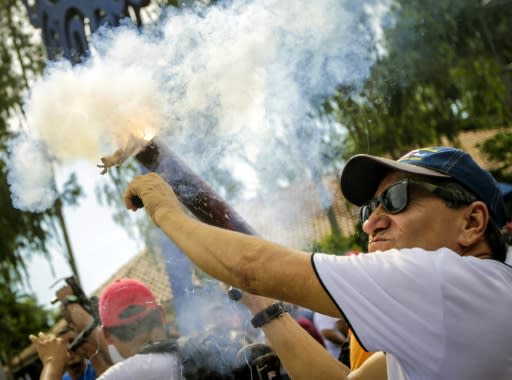 Supporters of Nicaraguan President Daniel Ortega fire mortars during a rally in the capital Managua