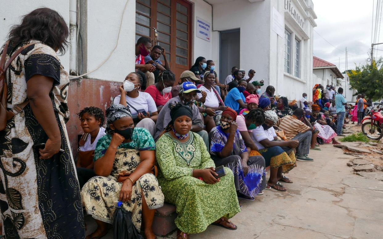 People await the arrival of ships from Palma district with people fleeing attacks by rebel groups, in Pemba, Mozambique - LUIS MIGUEL FONSECA/EPA-EFE/Shutterstock 