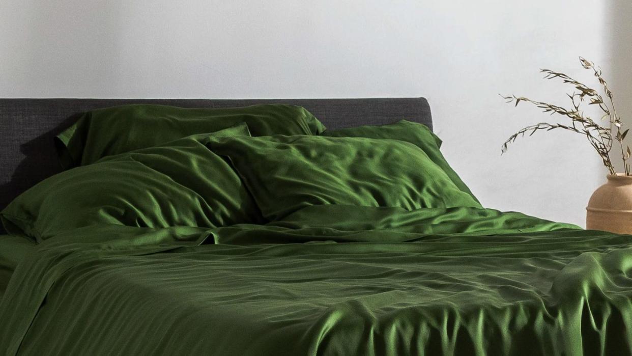 a green bed with a green comforter