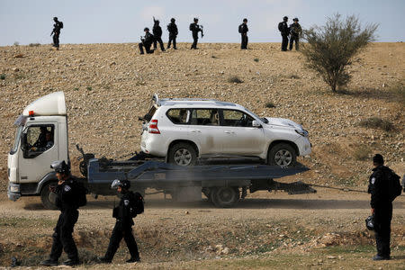 A car, which Israeli police said was used to ram into a group of policemen, is towed by Israeli police in Umm Al-Hiran, a Bedouin village in Israel's southern Negev Desert January 18, 2017. REUTERS/Amir Cohen