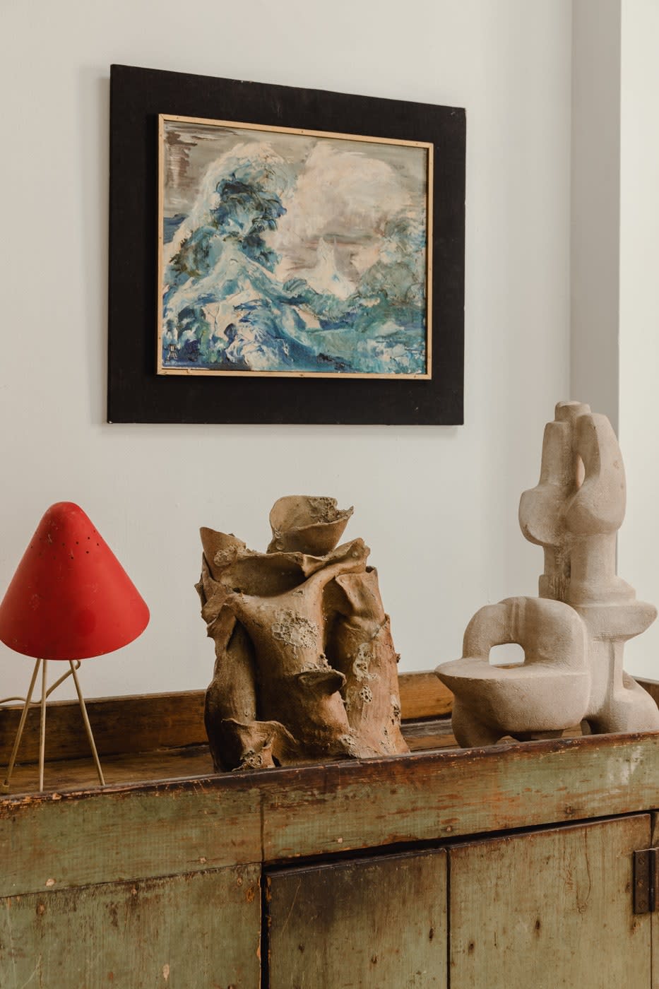 “I found this crazy ceramic that reminds me of the ceramist Peter Voulkos,” says Jonny of the centerpiece sandwiched between a 1960s metal lamp and a stone sculpture by Bernice Dritz-Epstein. “It’s just wild and weird. I got that at Brimfield from a dealer friend.”