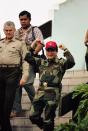 <p>Panamanian Gen. Manuel Antonio Noriega emerges from his military headquarters in Panama City, Oct. 4, 1989, a day after a failed coup attempt. President George H.W. Bush refuses to rule out military action to oust the leader, but the next U.S. moves are more likely to involve dollars than bullets. (AP Photo/John Hopper) </p>