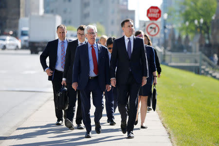 Canada's Finance Minister Bill Morneau (R) and Natural Resources Minister Jim Carr walk to a news conference about the state of the Kinder Morgan pipeline expansion in Ottawa, Ontario, Canada, May 29, 2018. REUTERS/Chris Wattie