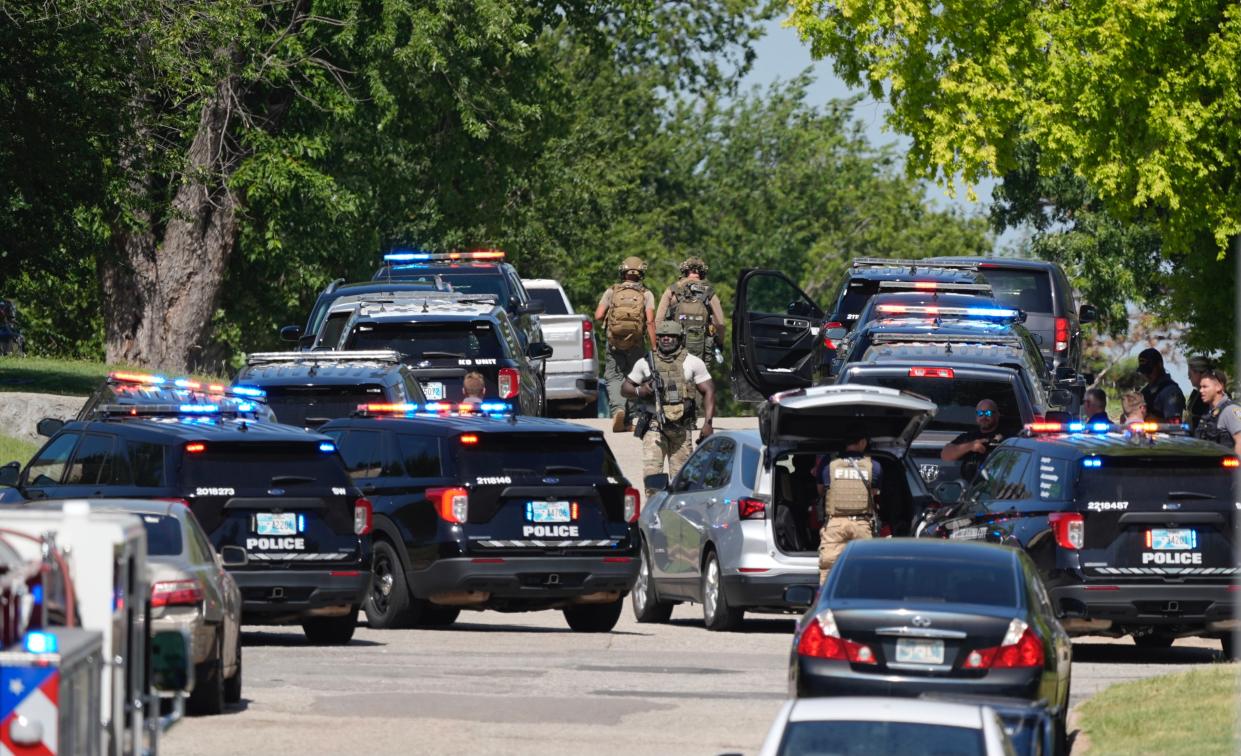 Law enforcement officers surround the 2200 block of W Eubanks Street in Oklahoma City on Tuesday after a suspect reportedly shot at officers while barricaded in a home.