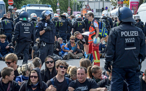 Counter-protesters block a street - Credit: EPA/CLEMENS BILAN