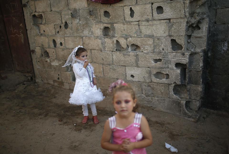 Relatives of young Palestinian groom Ahmed Soboh and bride Tala take part in wedding party in the town of Beit Lahiya