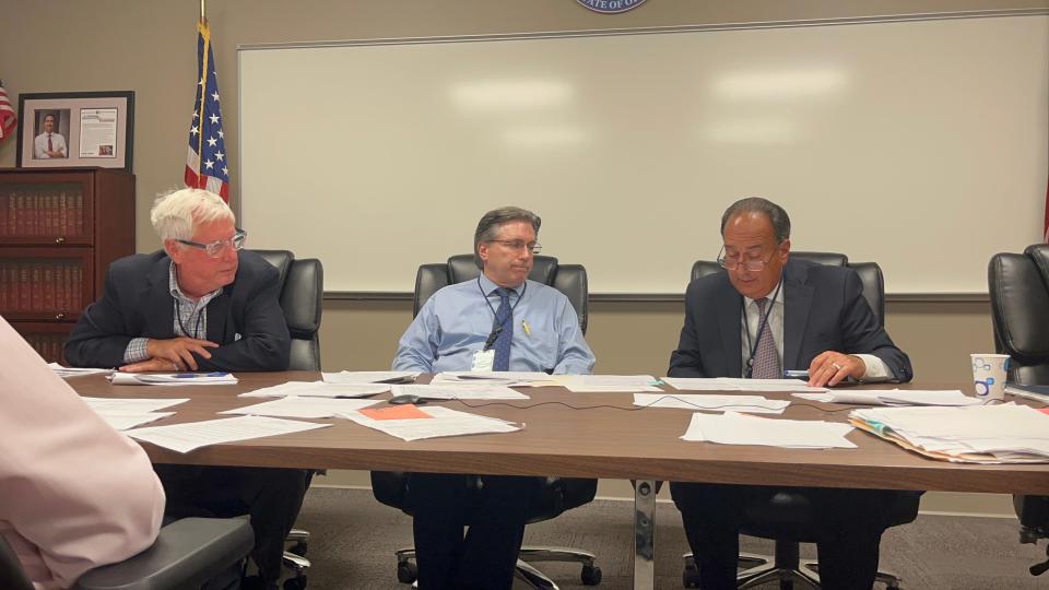 Members of the Stark County Board of Elections, left to right, Curt Braden, James Mathews and Samuel Ferruccio examine candidates' petitions Monday to determine if one person signed for two people. The board, which met at its office on Regent Avenue NE in Canton, voted not to certify 11 candidates for the November ballot due to petition issues.