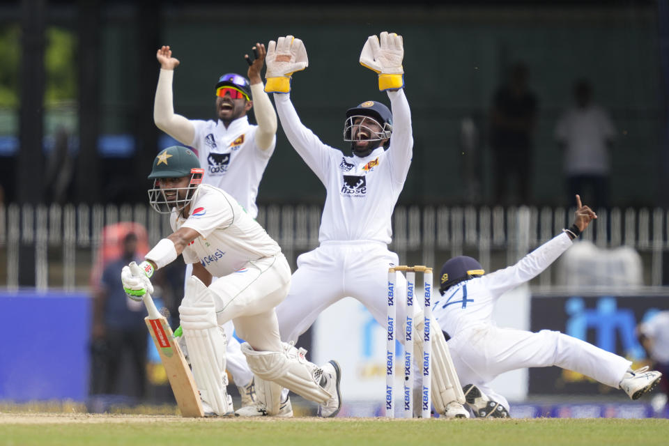 Sri Lanka's wicketkeeper Sadeera Samarawickrama appeals successfully with others to dismiss Pakistan's captain Babar Azam during the third day of the second cricket test match between Sri Lanka and Pakistan in Colombo, Sri Lanka on Wednesday, Jul. 26. (AP Photo/Eranga Jayawardena)