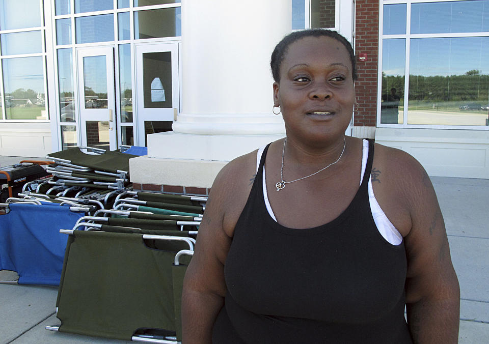 In this Tuesday, Sept. 18, 2018, photo, Lutrice Garcia stands outside a Red Cross shelter where she's staying, at a school in Bennettsville, S.C. Garcia said her nearby home was damaged by flooding caused by Hurricane Florence, and she doesn't know if she'll be able to return there to live once the water recedes. (AP Photo/Russ Bynum)