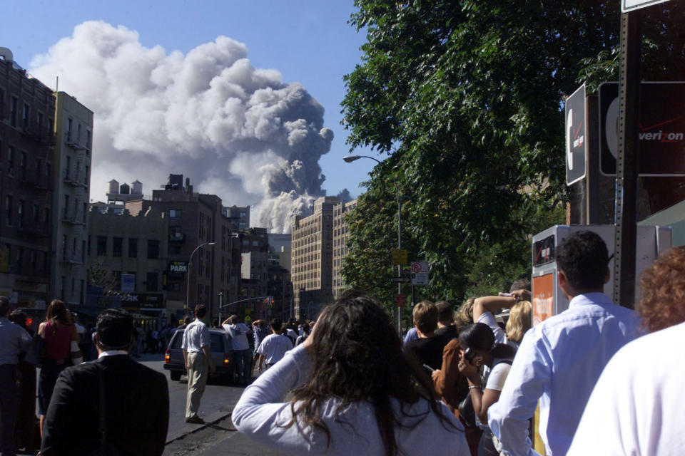 People watch as the second of two World Trade Center towers collapse after planes crashed into the buildings in New York on September 11, 2001. (Peter Morgan/Reuters)