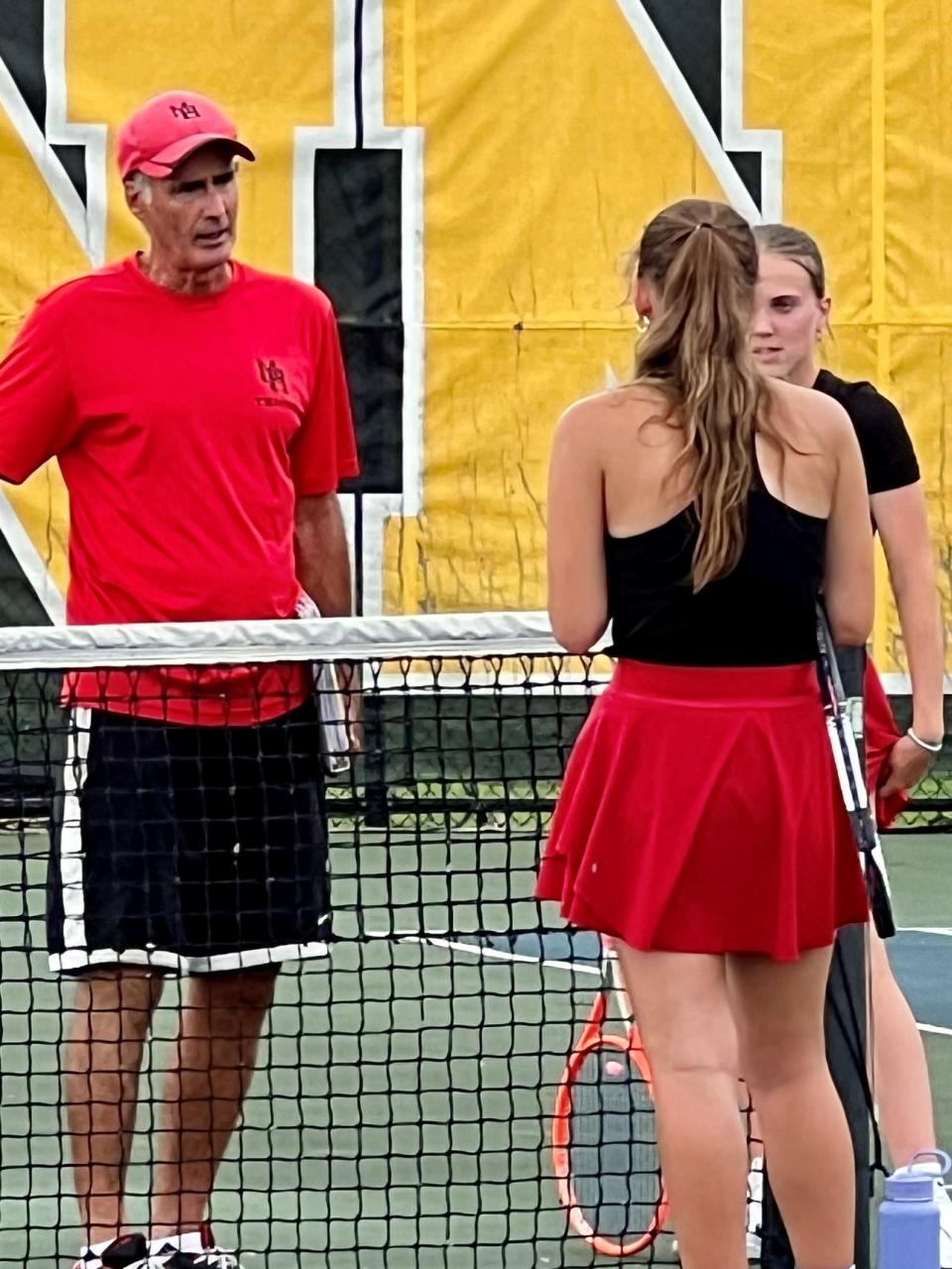 Marion Harding tennis coach Blaine Pitts talks to the doubles team of Sophie Beechum (facing) and Autumn Silverio during a match earlier this year at Westerville North.