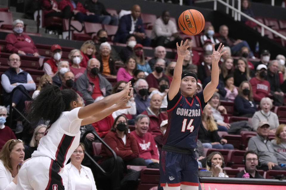 Gonzaga guard Kaylynne Truong (14) takes a 3-point shot against Stanford guard Agnes Emma-Nnopu (2) during the first half of an NCAA college basketball game in Stanford, Calif., Sunday, Dec. 4, 2022. (AP Photo/Tony Avelar)