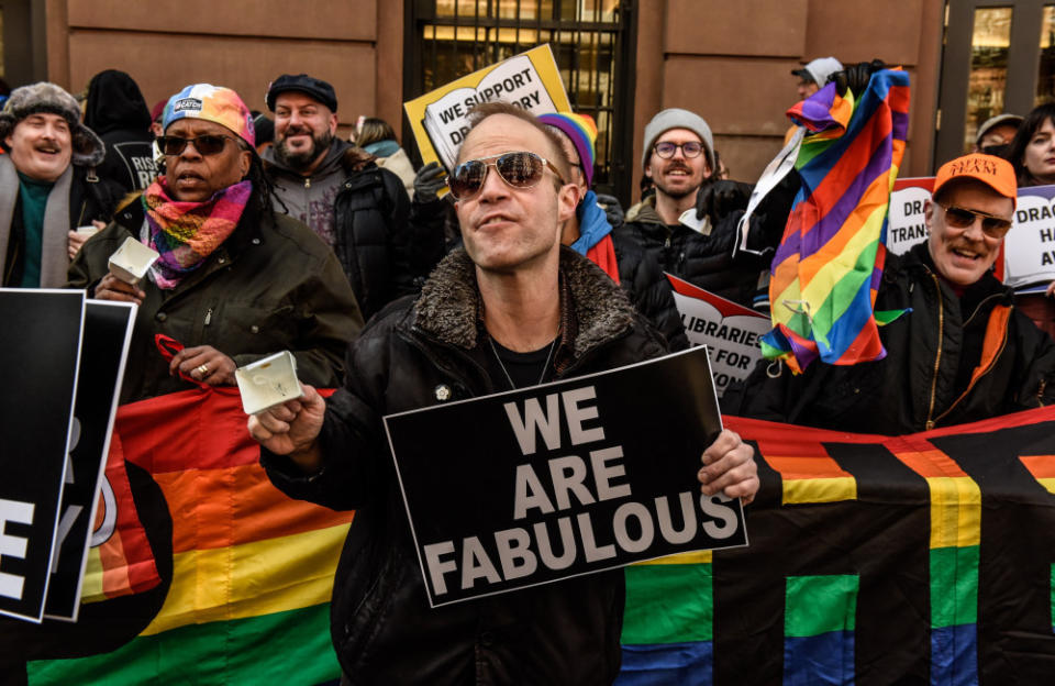 LGBTQIA+ protesters hold signs outside The Center in support of a Drag Queen Story hosted in New York.