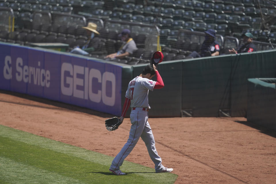 Los Angeles Angels' Shohei Ohtani (17) walks toward the dugout after being relieved during the first inning of a baseball game against the Oakland Athletics in Oakland, Calif., Sunday, July 26, 2020. (AP Photo/Jeff Chiu)