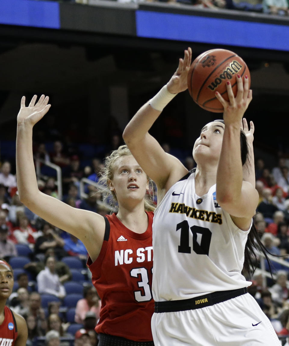 FILE - In this March 30, 2019, file photo, Iowa's Megan Gustafson (10) shoots against North Carolina State's Elissa Cunane (33) during the second half of a regional women's college basketball game in the NCAA Tournament in Greensboro, N.C. Former Iowa star Gustafson was drafted by the WNBA Dallas Wings before getting cut just before final rosters were announced. The AP Player of the Year will be competing with an Iowa alumni team in The Basketball Tournament. (AP Photo/Gerry Broome, File)