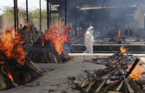 Multiple funeral pyres of people who died of COVID-19 burn at the Ghazipur crematorium in New Delhi, India, Thursday, May 13, 2021. (AP Photo/Amit Sharma)