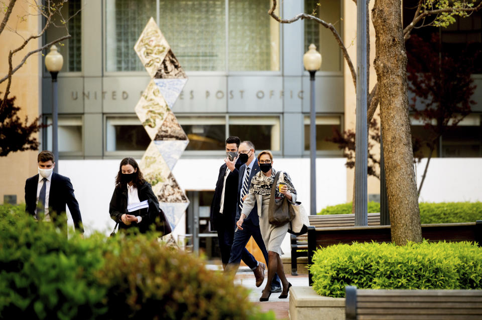 Epic Games CEO Tim Sweeney, second right, approaches the Ronald V. Dellums building in Oakland, Calif., to attend his company's federal court case against Apple on Monday, May 3, 2021. Epic, maker of the video game Fortnite, charges that Apple has transformed its App Store into an illegal monopoly. (AP Photo/Noah Berger)