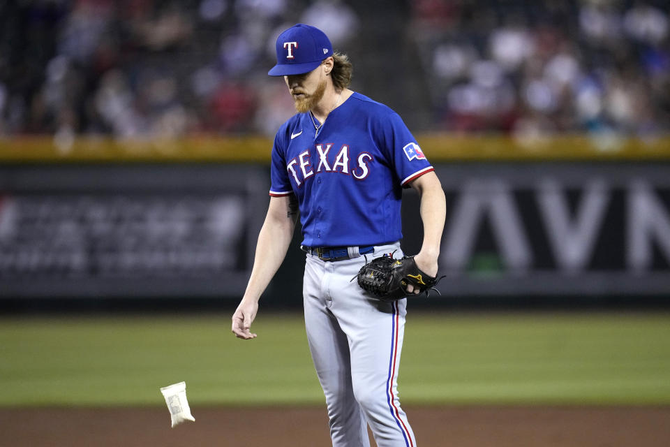 Texas Rangers starting pitcher Jon Gray tosses the rosin bag down during the second inning of the team's baseball game against the Arizona Diamondbacks on Tuesday, Aug. 22, 2023, in Phoenix. (AP Photo/Ross D. Franklin)